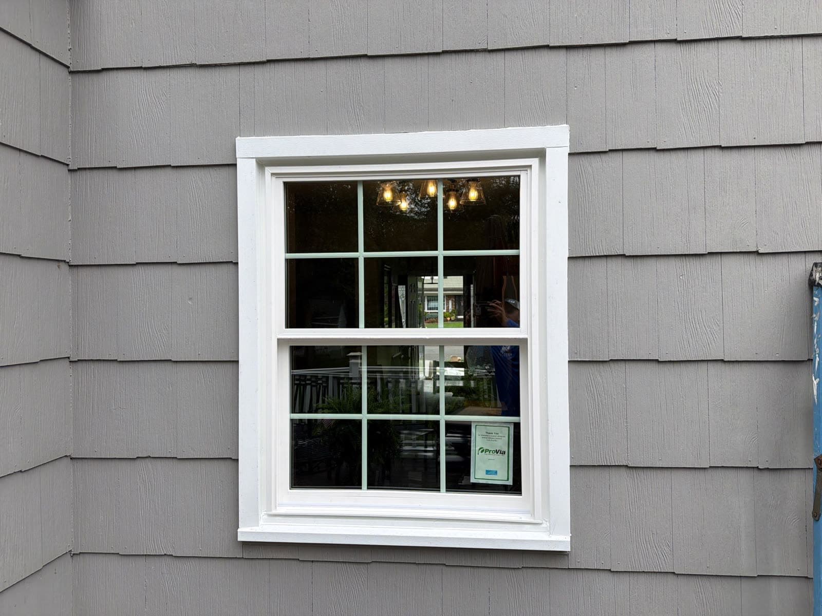Finished ProVia colonial-grid replacement window in clean white trim on a New Jersey home